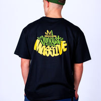 Person wearing a black Junglist Massive t-shirt with colourful text on the back against a plain background