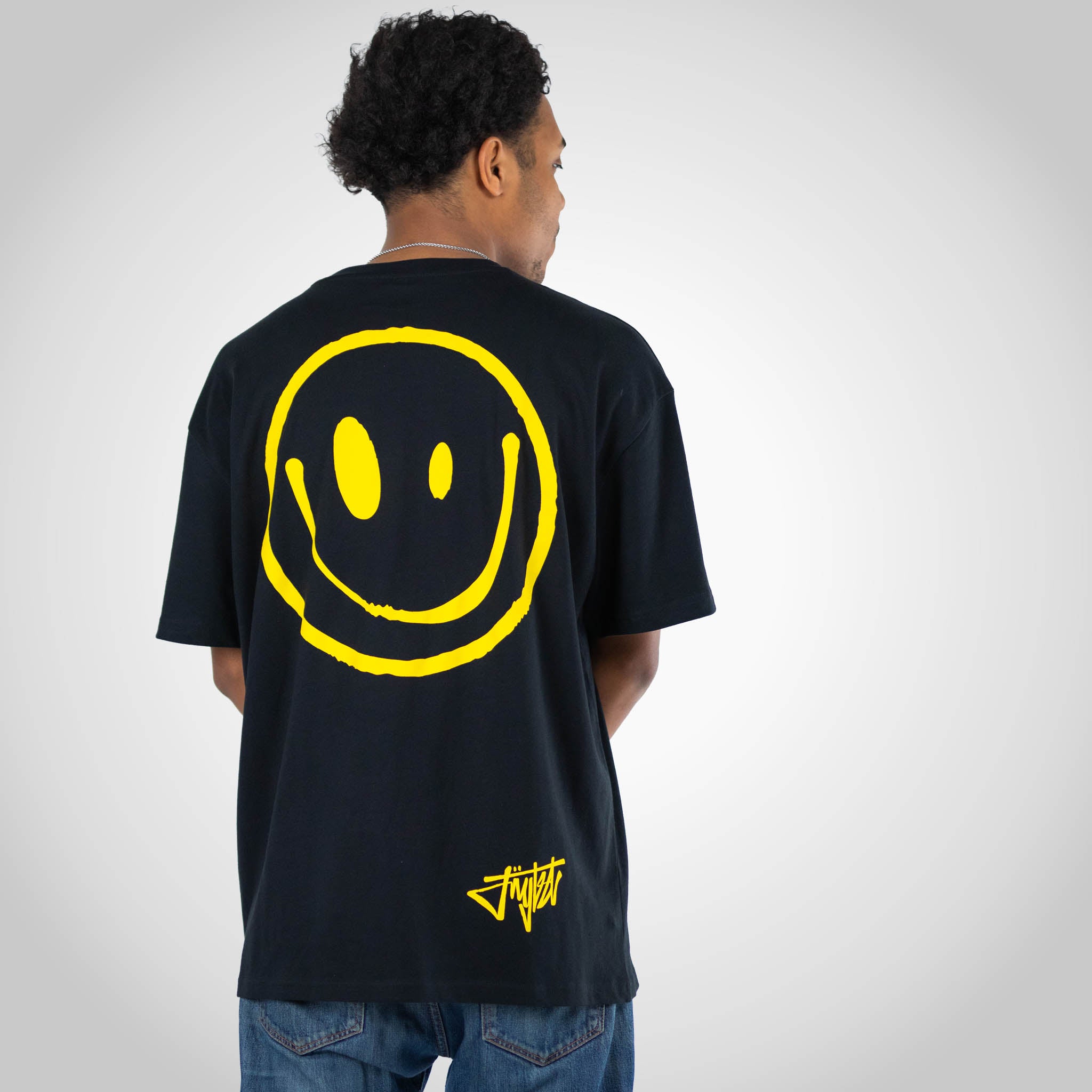 Smiley Rewired Black T Shirt worn by model wearing jeans