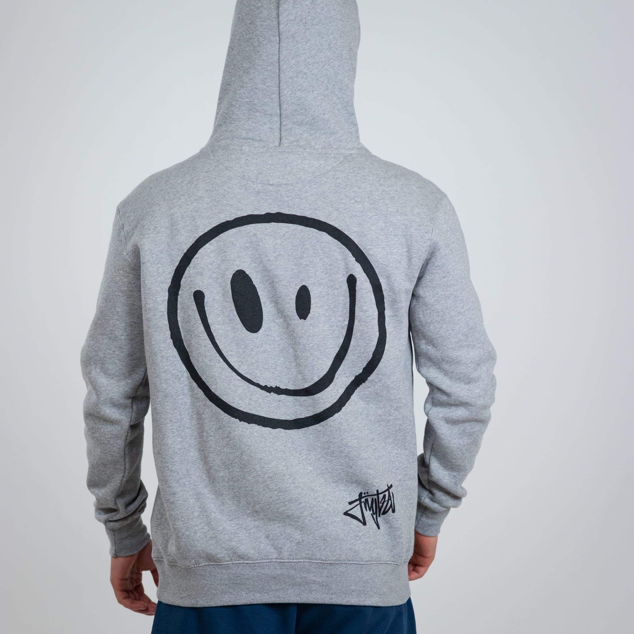 Gray hoodie with a smiley face design on the back against a white background