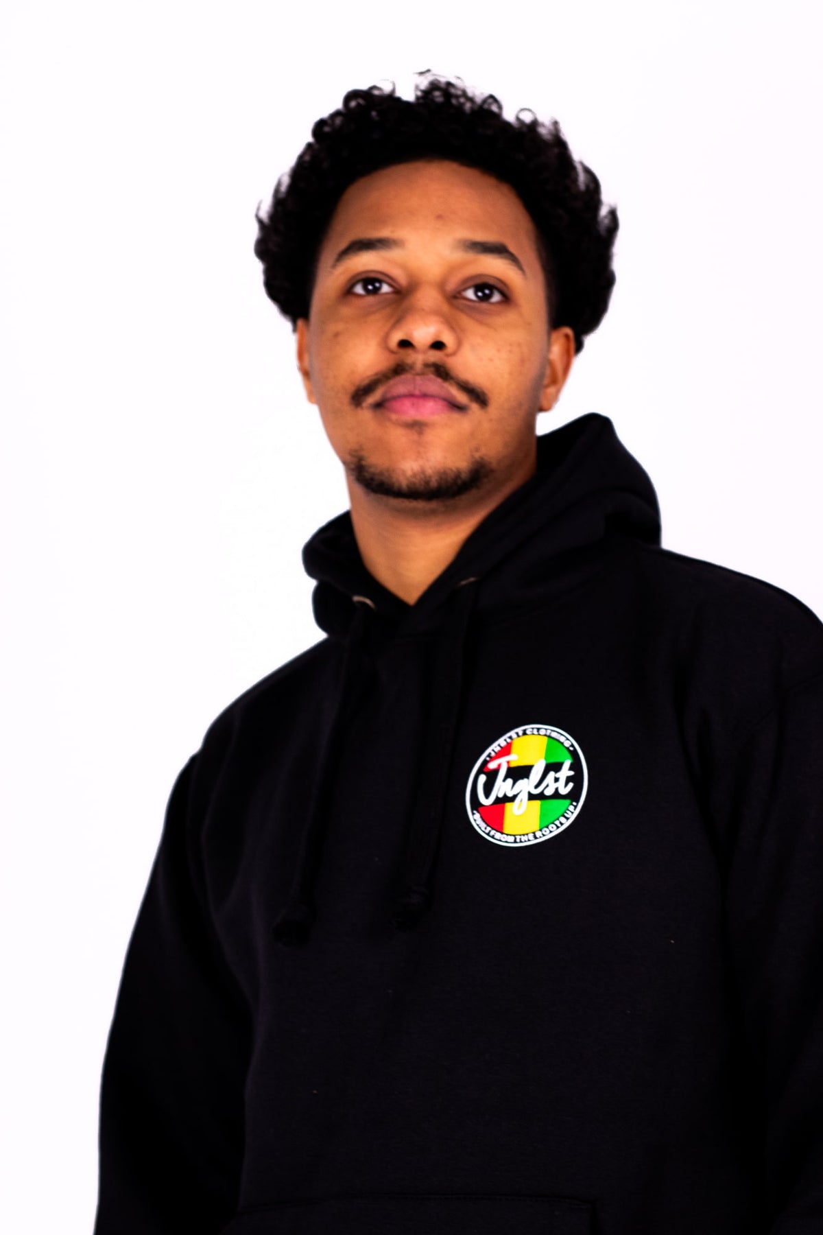 Person wearing a black hoodie with a colorful logo on a white background