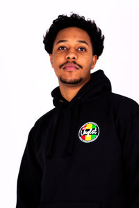 Person wearing a black hoodie with a colorful logo on a white background