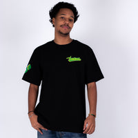 Person wearing a black t-shirt with green text and logo on a white background