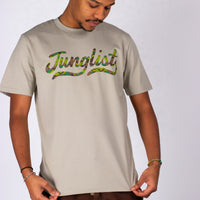 Person wearing a beige t-shirt with 'Junglist' printed in colorful letters on a white background