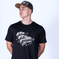 Person wearing a black t-shirt with white graphic design and a cap on a light gray background