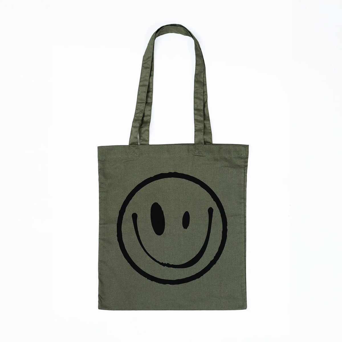 An olive green canvas tote bag with a large black hand-drawn smiley face printed on the front, set against a plain white background.