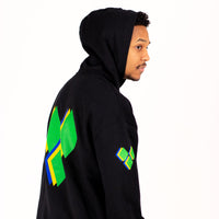 Person wearing a black yardrock diamond hoodie with colorful designs on the back against a white background