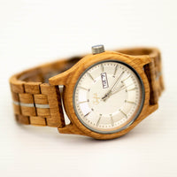 Wooden Junglist wristwatch with a white face on a light background