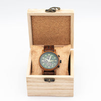 Wooden Junglist watch with a detailed face in a wooden box on a white background
