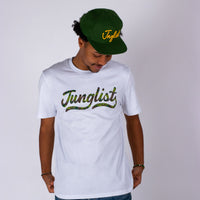 Person wearing a white t-shirt with 'Junglist' text and a green cap on a plain background