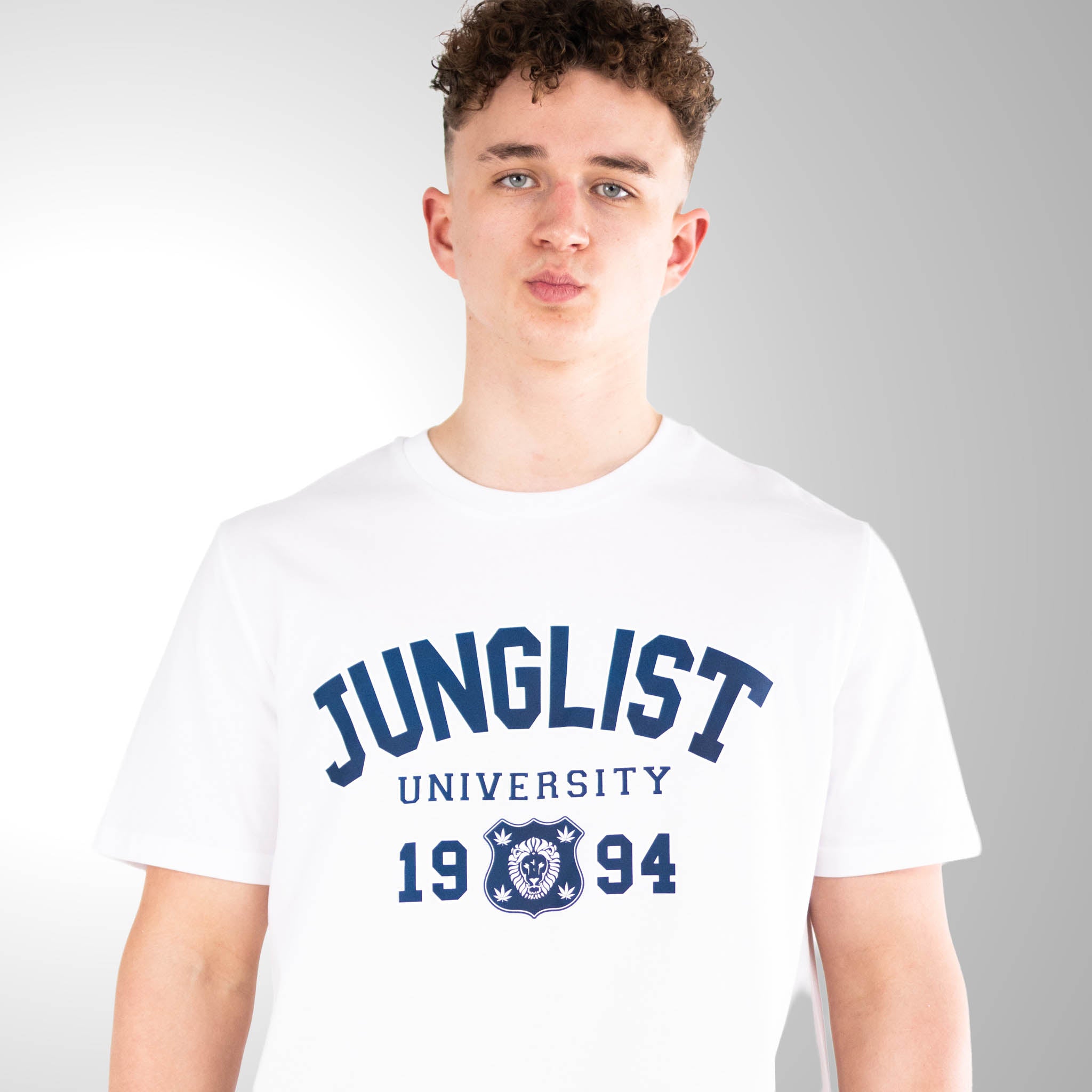 Person wearing a white t-shirt with 'Junglist University 1994' text on a gray background