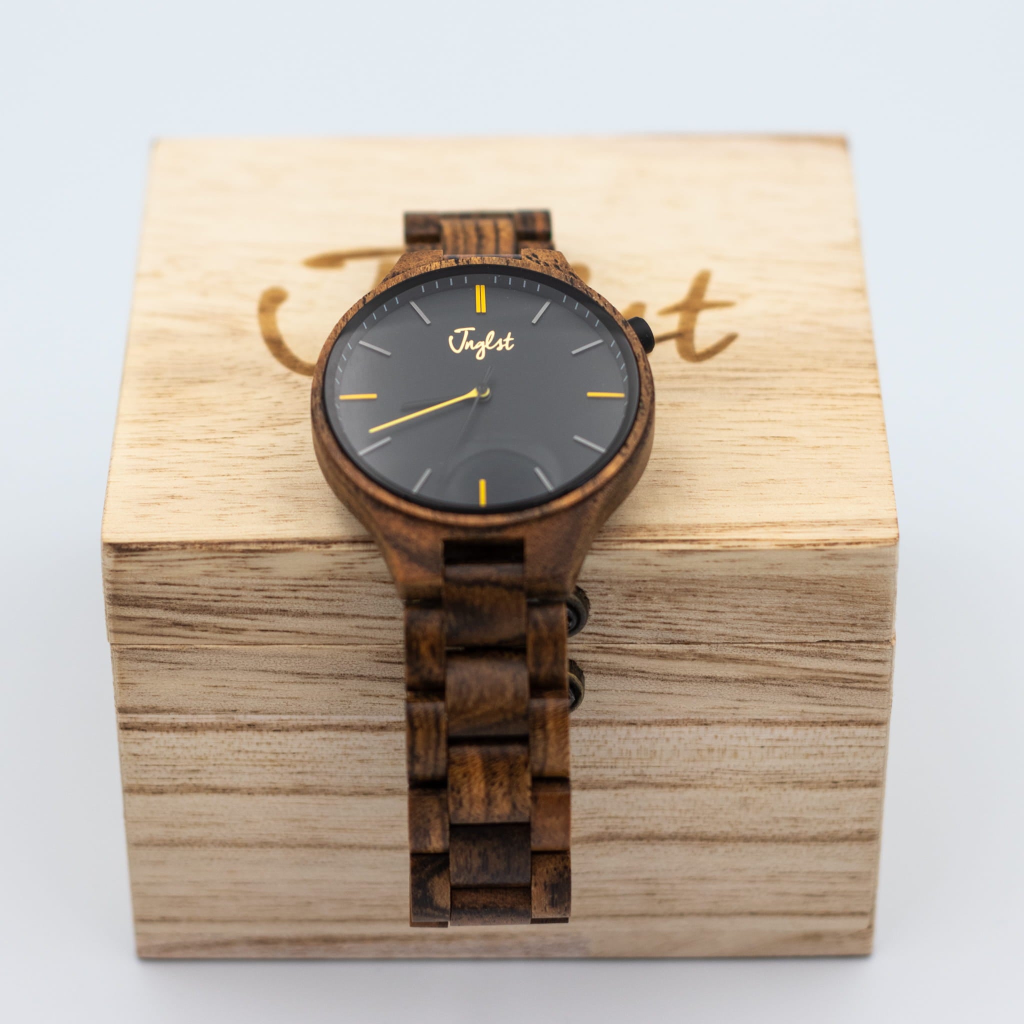 Wooden watch with black dial on a wooden Junglist case