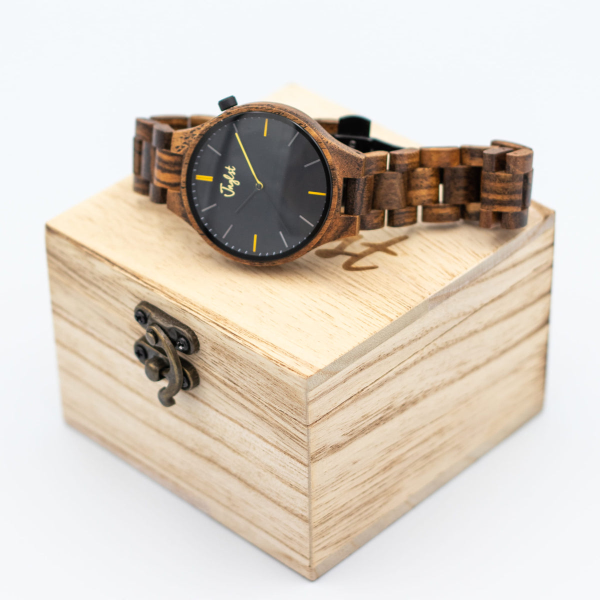 Wooden Junglist watch with black face and yellow accents on a wooden box
