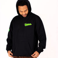 Person wearing a black yardrock diamond hoodie with green logo on a white background