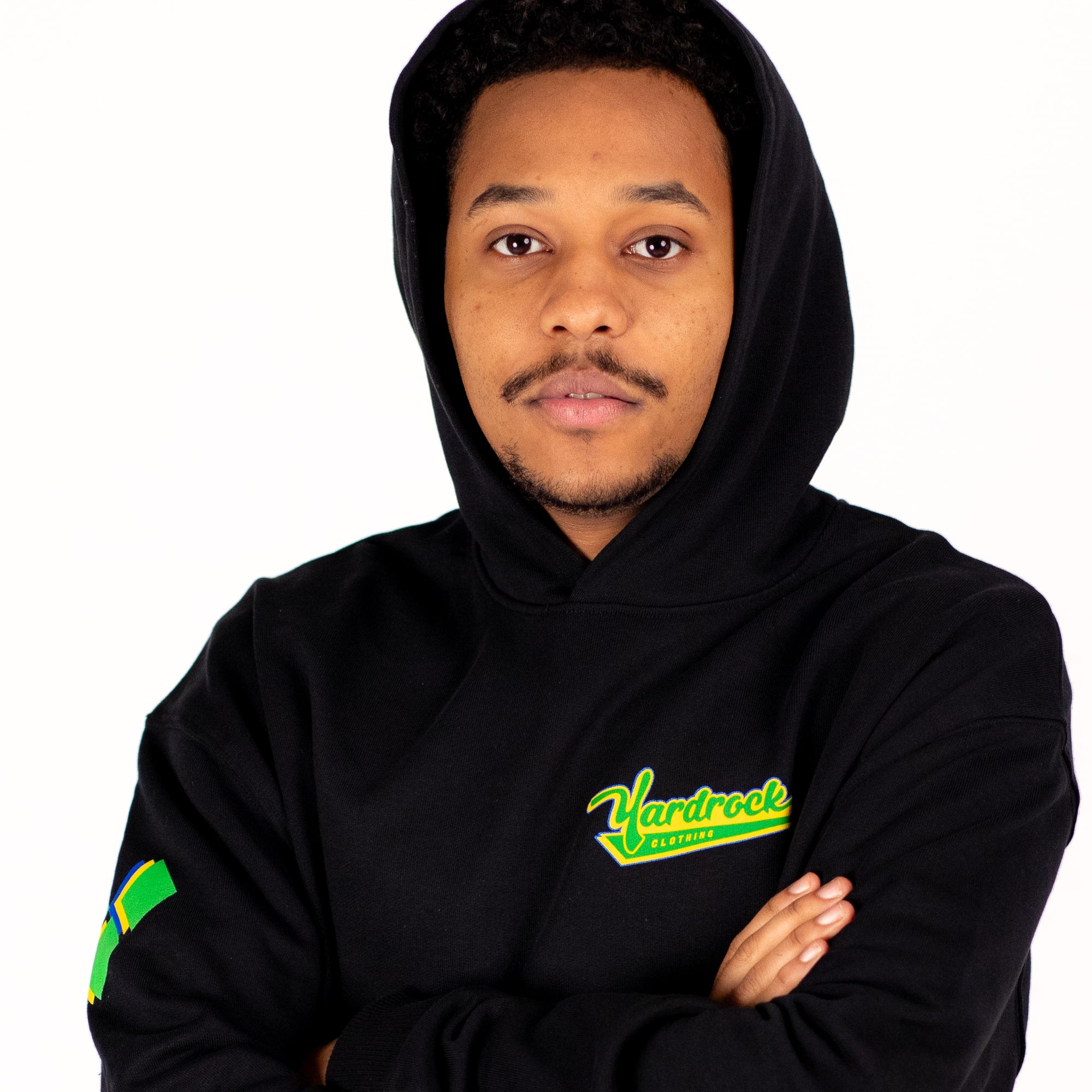 Person wearing a black yardrock diamond hoodie with a visible brand logo on a white background