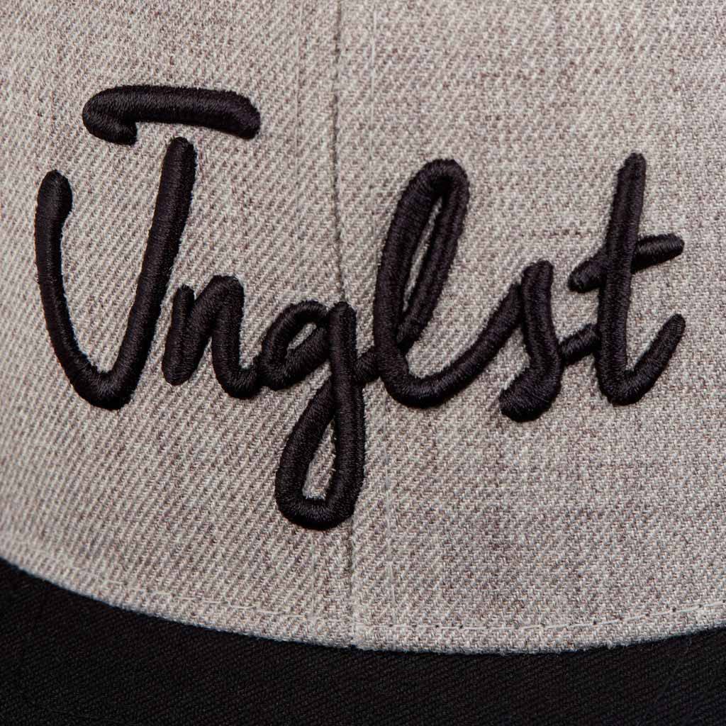 Close up of Jnglst embroidery on Snapback