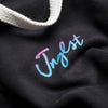 Close up Jnglst Logo in faded colours on the Front of our Hoodie