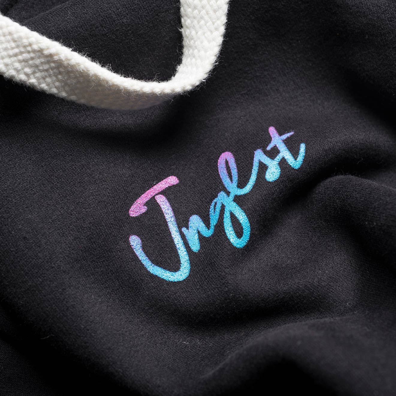Close up Jnglst Logo in faded colours on the Front of our Hoodie