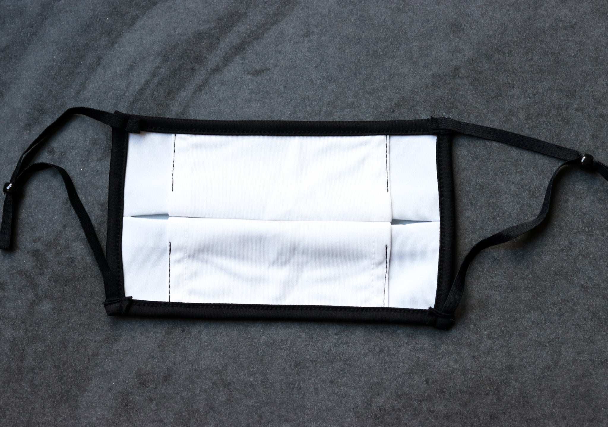 The Inside Of Our Camo Face Mask Showing Adjustable Ear Toggles